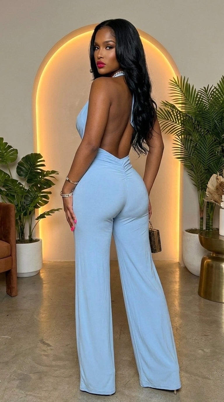 Deme & Anor Skyfall halter jumpsuit in black, featuring a fitted bodice and wide-leg pants, displayed on a hanger.